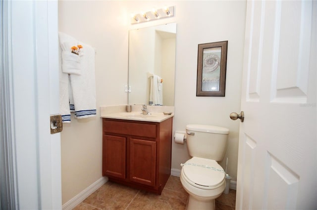 bathroom featuring tile patterned flooring, vanity, and toilet