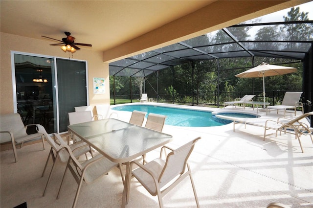 view of pool with a patio, a lanai, and an in ground hot tub