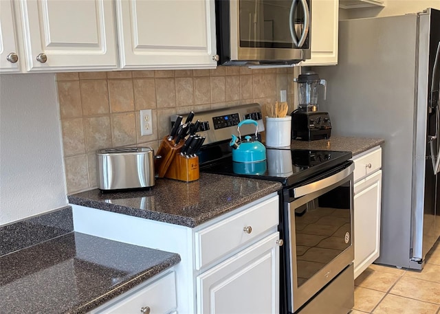 kitchen featuring white cabinetry, stainless steel appliances, and light tile patterned floors