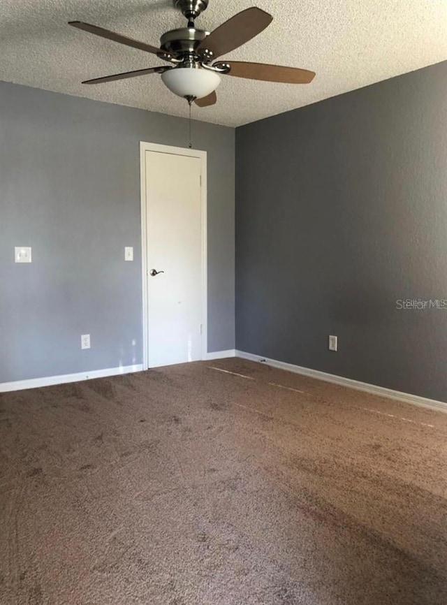 spare room with ceiling fan, a textured ceiling, and carpet flooring