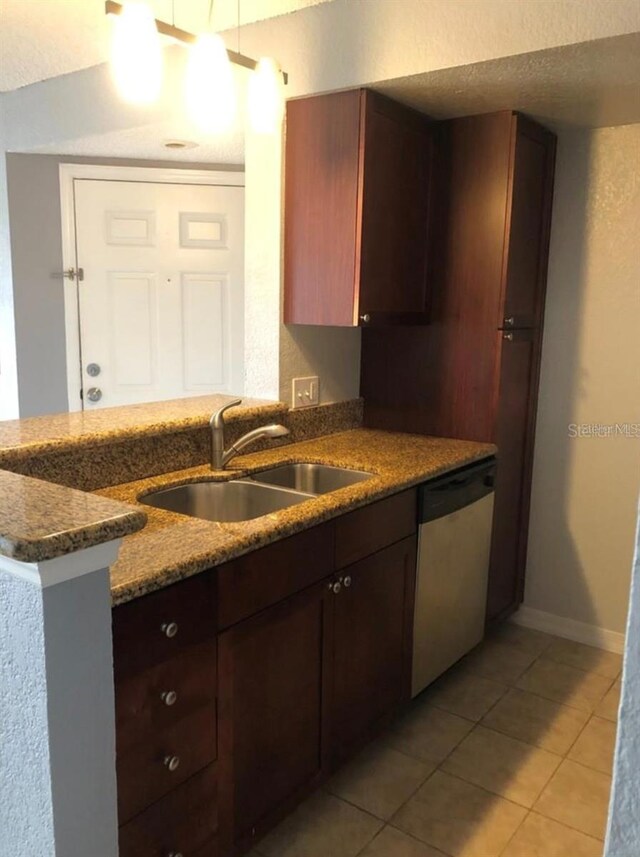 kitchen with light tile patterned flooring, stainless steel dishwasher, kitchen peninsula, and sink