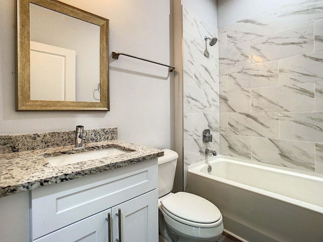 full bathroom featuring tiled shower / bath combo, vanity, and toilet