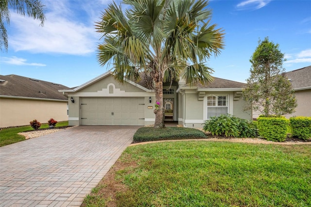 ranch-style home with a front yard and a garage