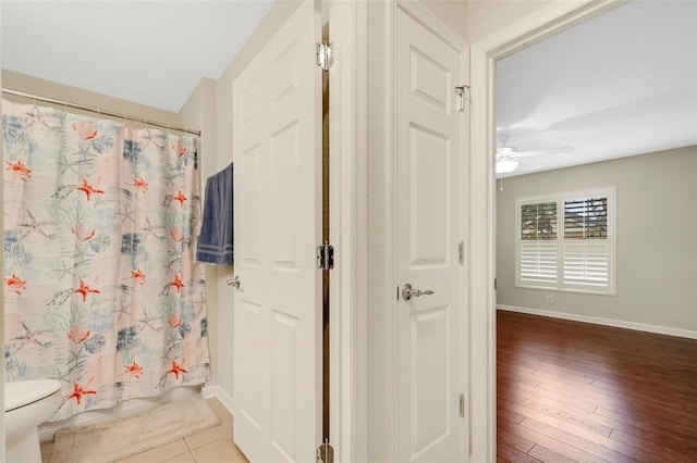 bathroom with toilet, hardwood / wood-style floors, and ceiling fan