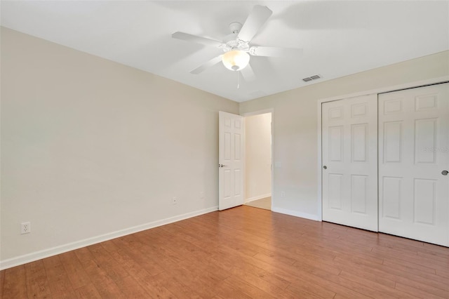 unfurnished bedroom with a closet, ceiling fan, and light wood-type flooring