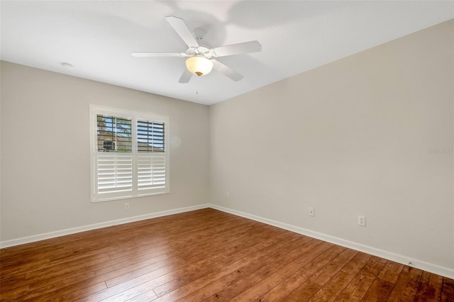 spare room featuring ceiling fan and dark hardwood / wood-style floors