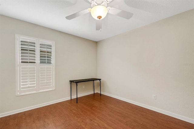 spare room with ceiling fan and hardwood / wood-style flooring