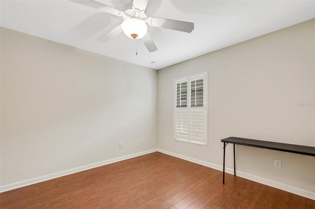 unfurnished room featuring dark hardwood / wood-style flooring and ceiling fan