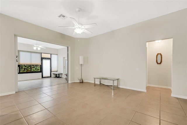 empty room featuring ceiling fan and light tile floors