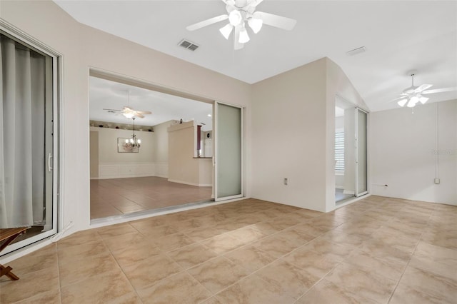 spare room with lofted ceiling, ceiling fan with notable chandelier, and light tile flooring