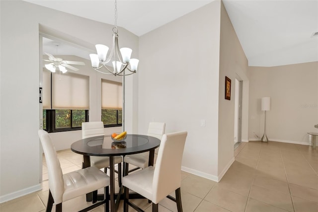 tiled dining space with lofted ceiling and ceiling fan with notable chandelier