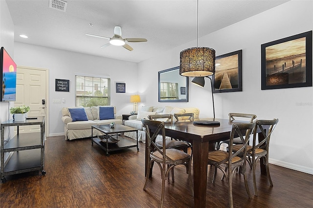 dining room with ceiling fan and dark hardwood / wood-style floors