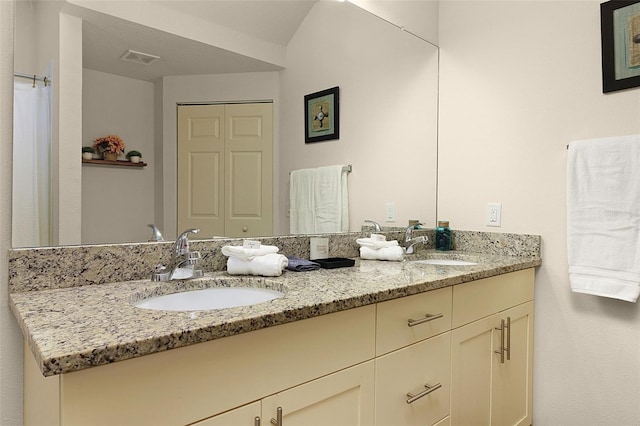 bathroom with dual sinks and oversized vanity