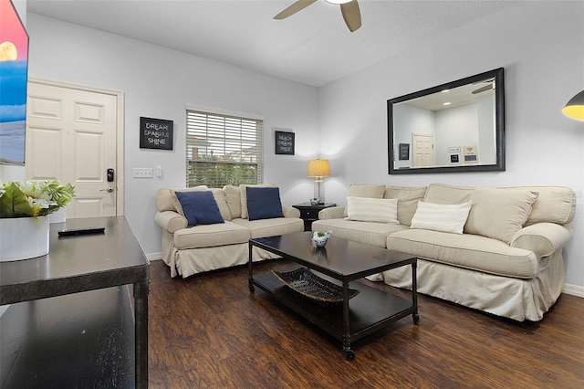 living room featuring ceiling fan and dark wood-type flooring