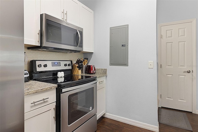 kitchen featuring light stone counters, dark hardwood / wood-style flooring, appliances with stainless steel finishes, tasteful backsplash, and white cabinetry