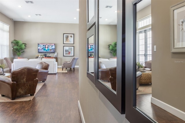 bedroom featuring multiple windows and dark hardwood / wood-style flooring