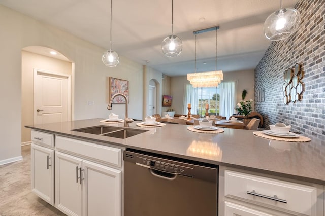 kitchen featuring white cabinets, sink, decorative light fixtures, and dishwashing machine