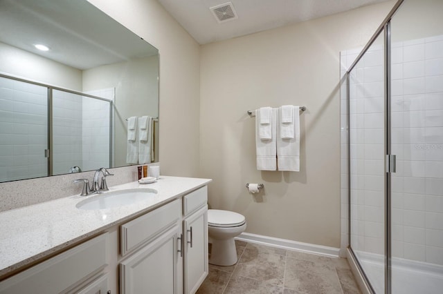 bathroom featuring tile floors, walk in shower, toilet, and vanity