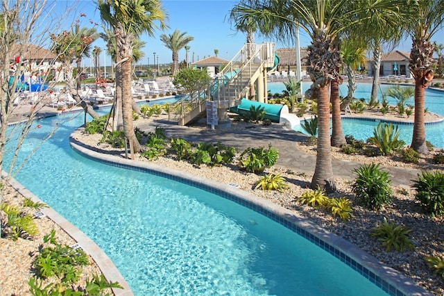 view of swimming pool with a water slide