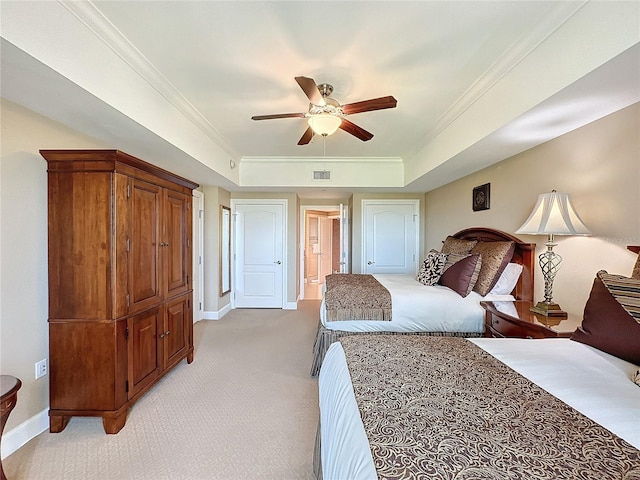 carpeted bedroom featuring a raised ceiling, ceiling fan, and ornamental molding