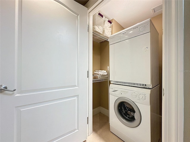 laundry area with stacked washer and clothes dryer