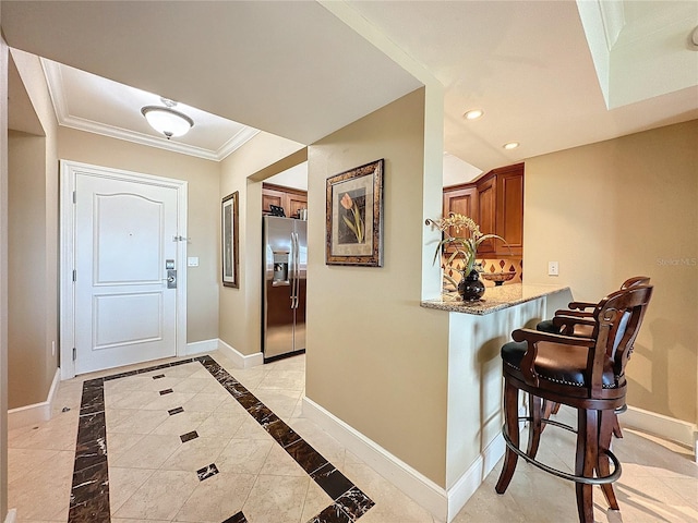 foyer featuring crown molding