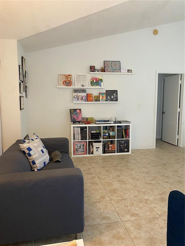 living room featuring light tile flooring and vaulted ceiling