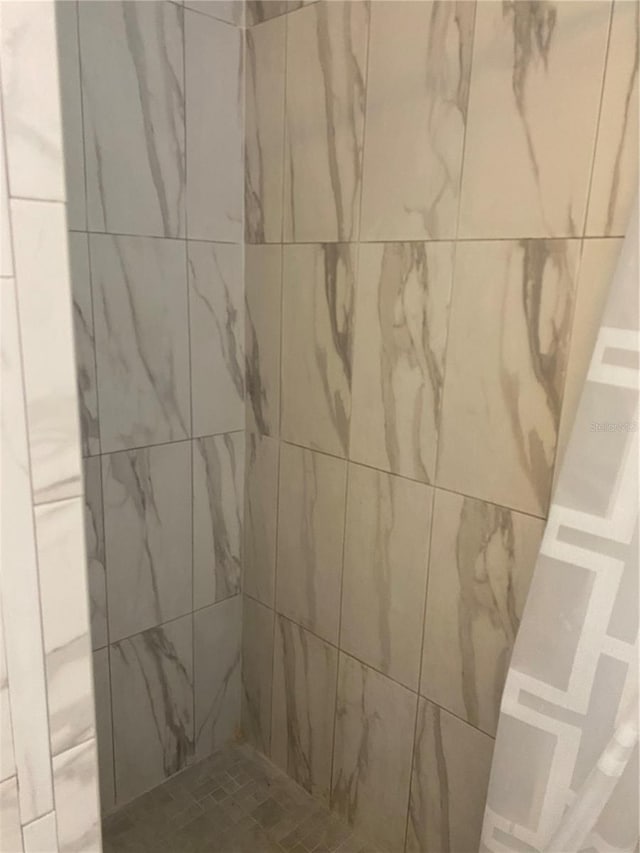 bathroom with a tile shower