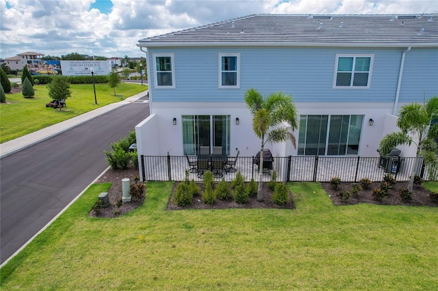 back of property featuring a lawn