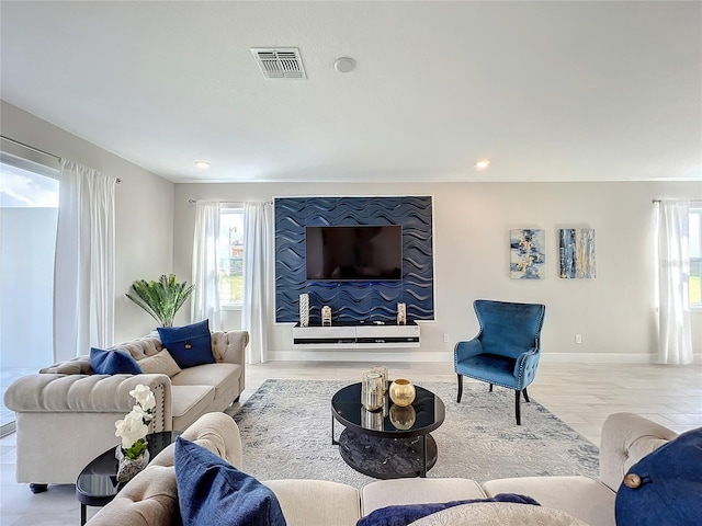 living room with light hardwood / wood-style flooring and a wealth of natural light