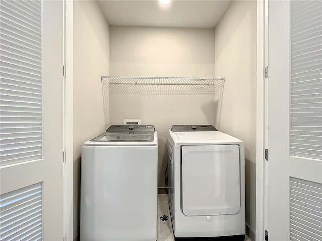 clothes washing area with washing machine and clothes dryer