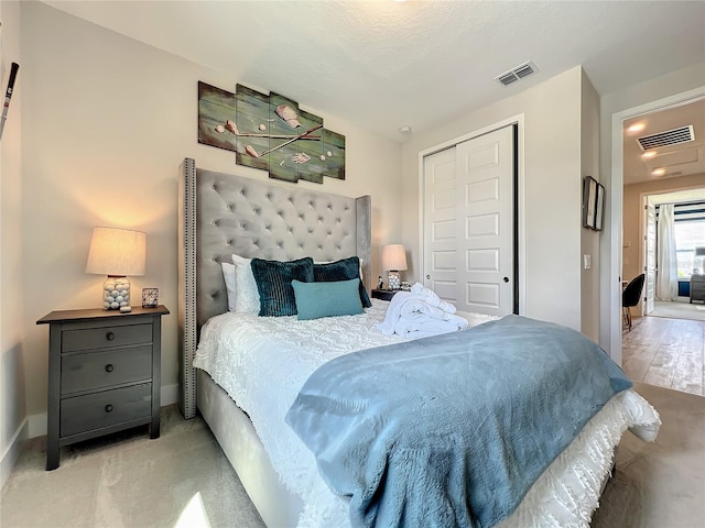 bedroom with a closet and light colored carpet