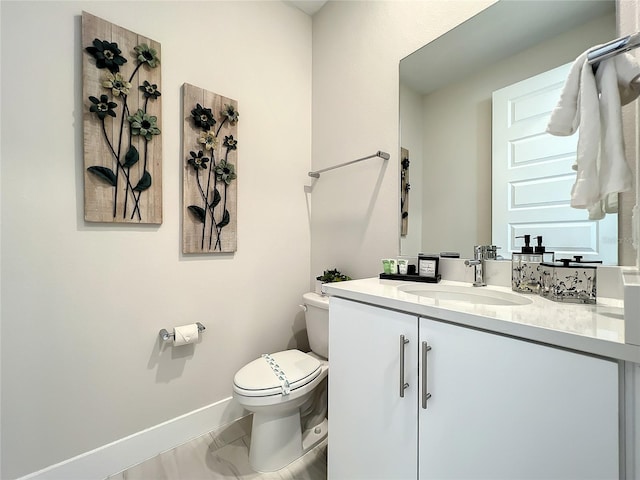 bathroom featuring tile floors, toilet, and vanity