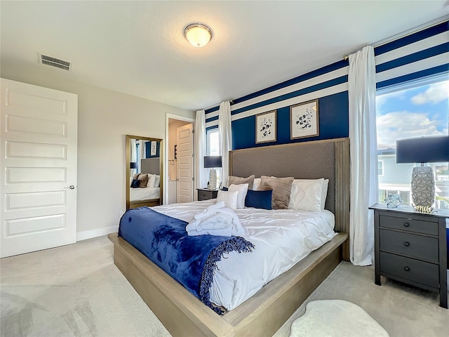 bedroom featuring light colored carpet