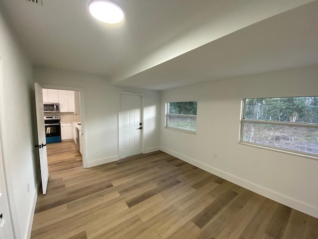 unfurnished bedroom featuring a closet and light hardwood / wood-style flooring