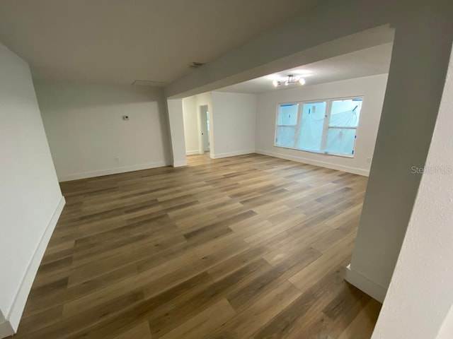 interior space with a notable chandelier and dark hardwood / wood-style flooring