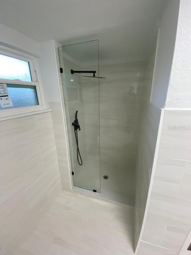 bathroom with a tile shower