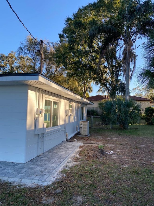 view of side of property featuring central air condition unit