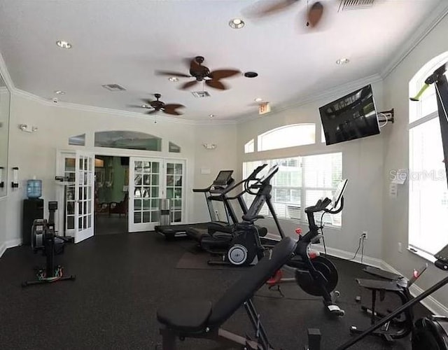 workout area featuring baseboards, french doors, visible vents, and crown molding