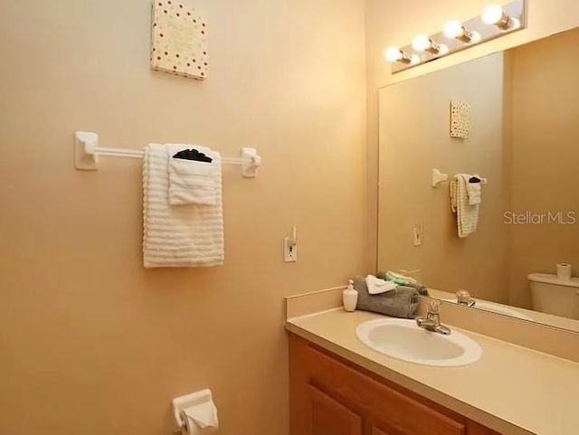 half bathroom with toilet and vanity