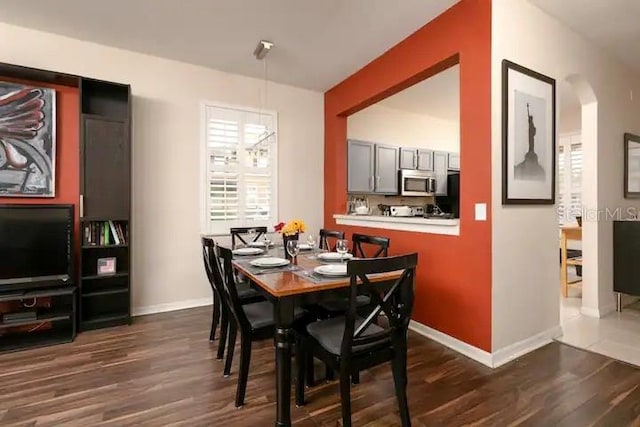 dining space featuring dark wood-type flooring