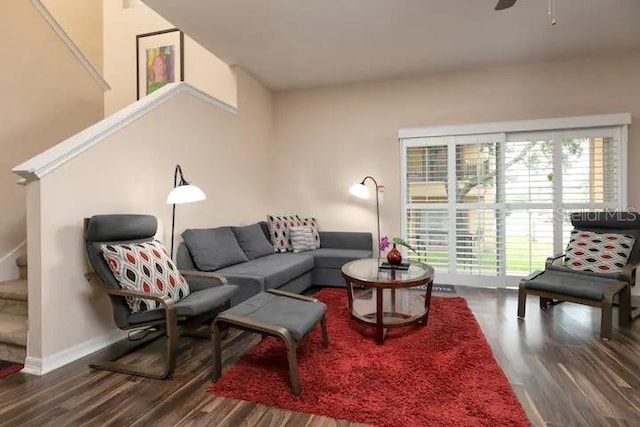 living room with dark hardwood / wood-style floors and ceiling fan