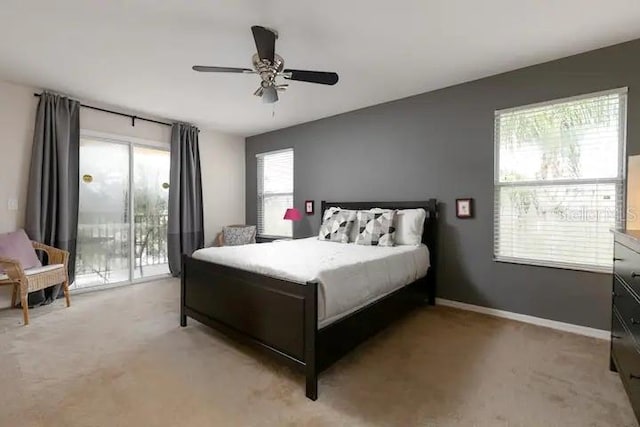 bedroom featuring access to outside, ceiling fan, and light colored carpet