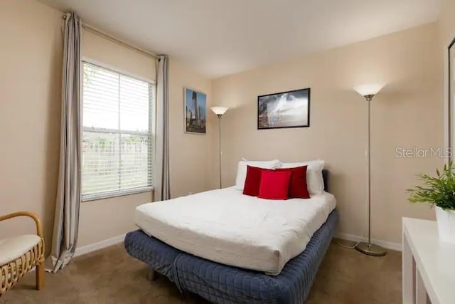 bedroom featuring light colored carpet