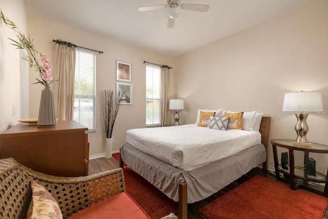 bedroom featuring ceiling fan and dark hardwood / wood-style flooring