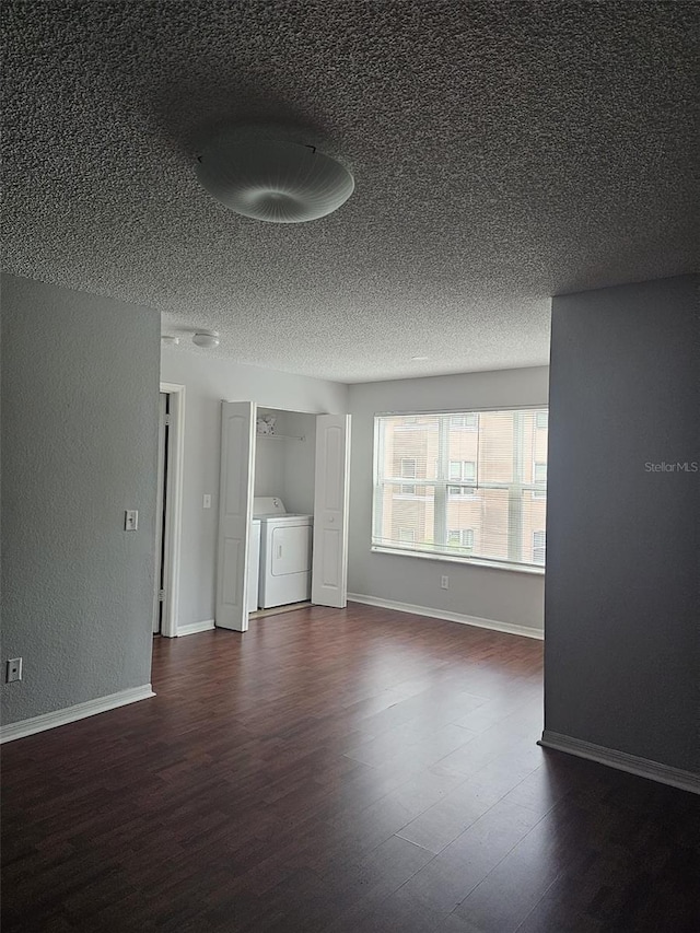 interior space featuring a textured ceiling, wood-type flooring, and independent washer and dryer