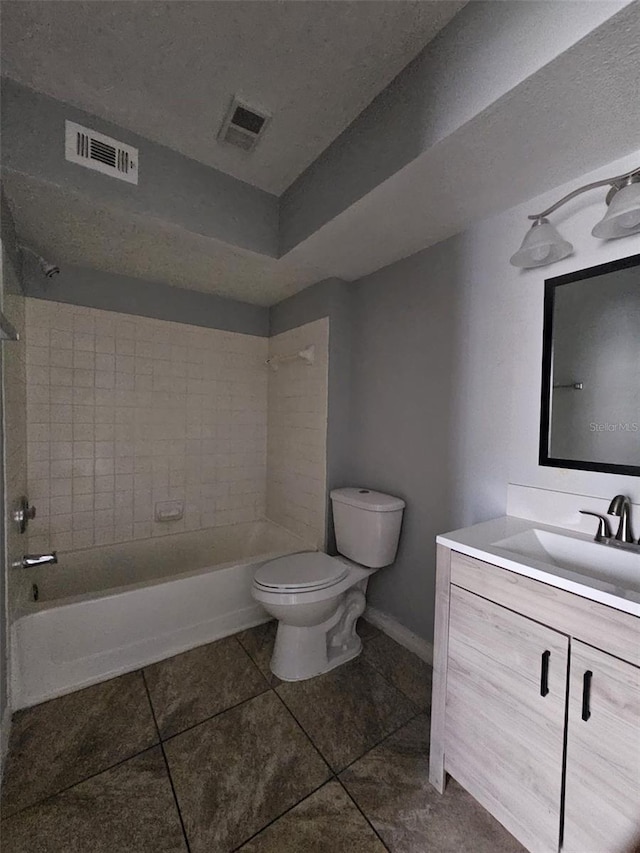 full bathroom featuring tile patterned floors, vanity, toilet, and tiled shower / bath combo