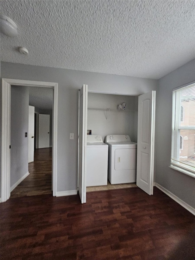 laundry room with separate washer and dryer, dark hardwood / wood-style floors, and a textured ceiling