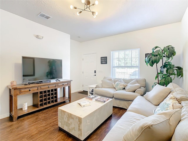 living room featuring dark hardwood / wood-style flooring and a chandelier