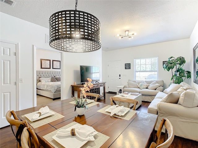 dining area featuring a textured ceiling and dark wood-type flooring